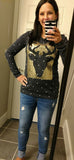 A polka-dot long sleeve top with sequins and a reindeer patch on front
